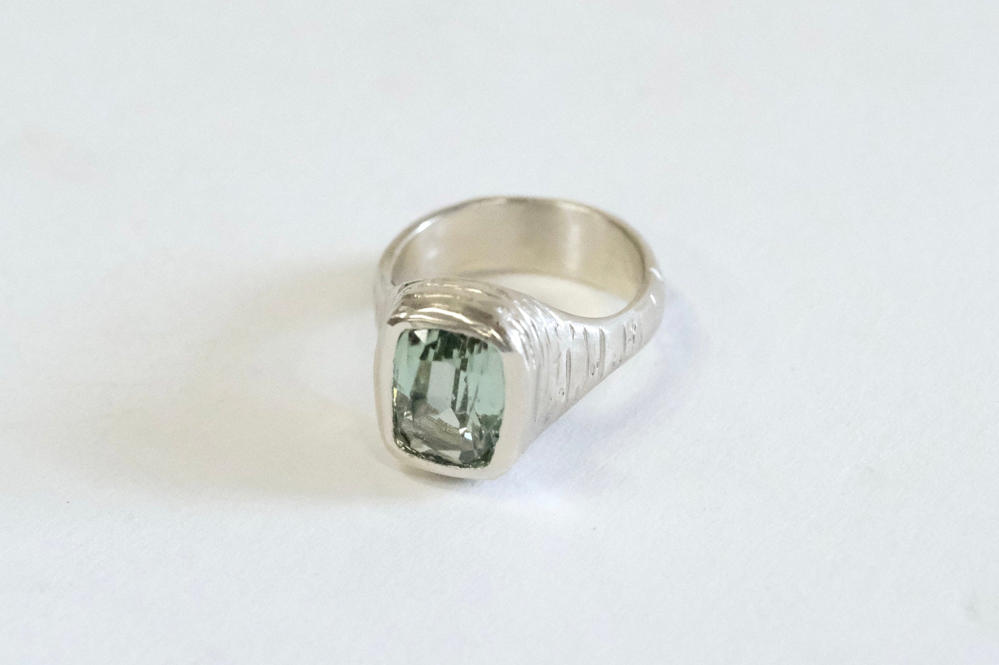 A Client Win! - an engagement ring with a mint green tourmaline in hand carved white gold